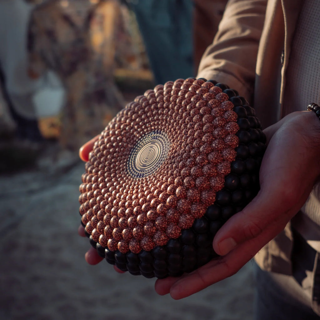 Man holding a disc orgonite